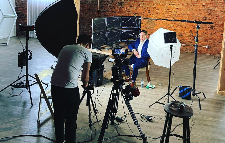 Camera operator lighting an executive interview set