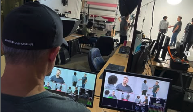 Producer watching multi-camera monitors on a field production set